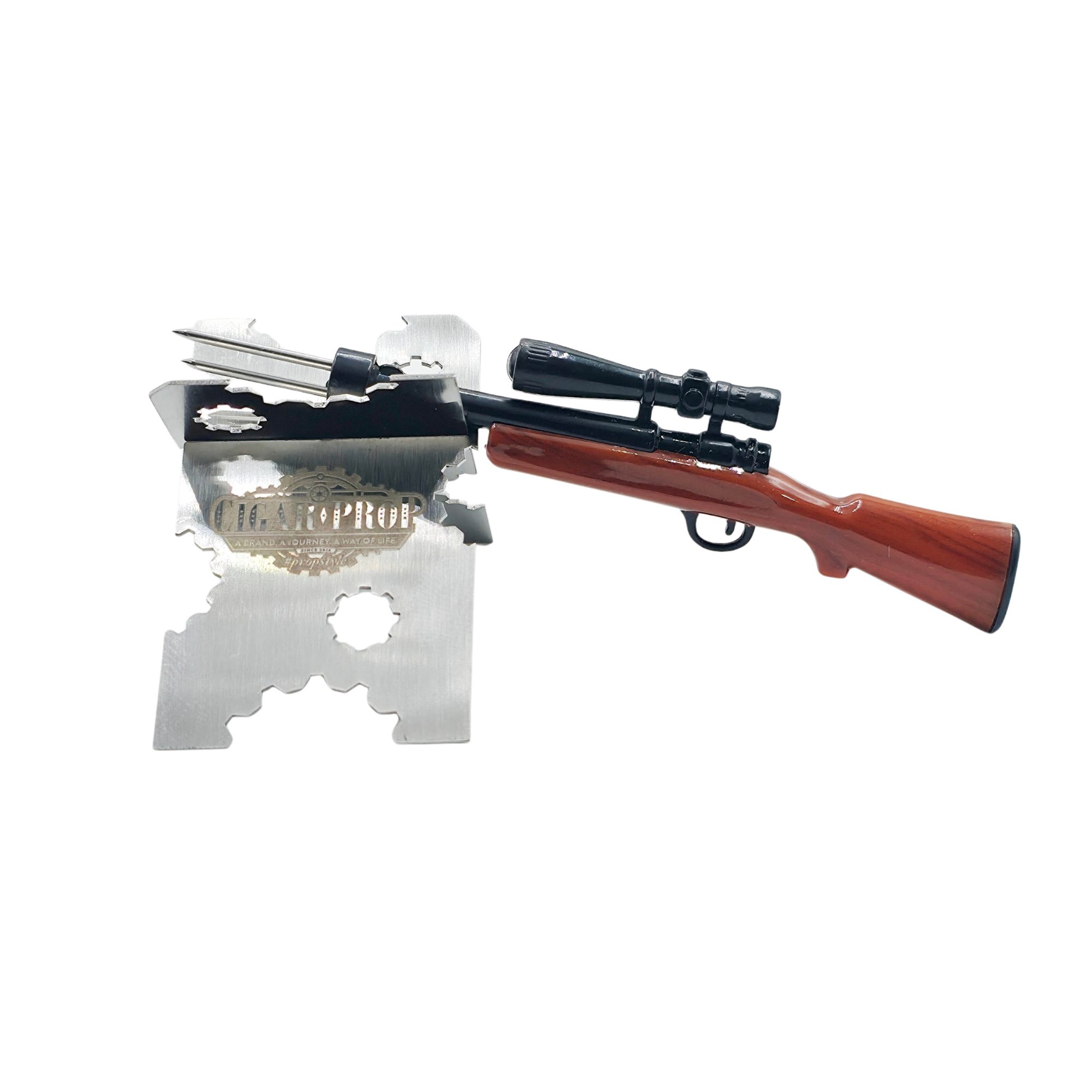 small novelty hunting rifle resting on a metal cigar holder