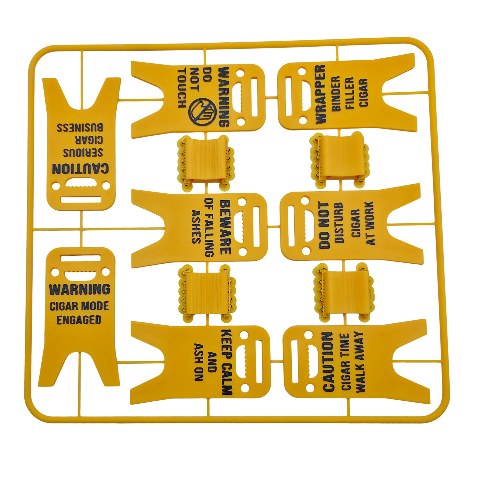 Bright yellow 3D printed cigar holder styled like a classic wet floor caution sign, printed with humorous cigar-related phrases in black text. The foldable design allows the sign to stand upright and serve as a portable cigar rest that keeps cigars elevated and off tables.